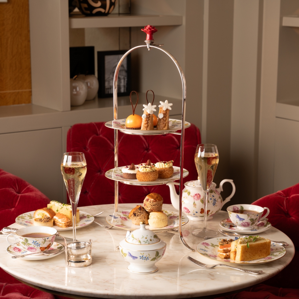 Indulge in a festive feast at The Rose Lounge! This delightful afternoon tea features seasonal treats, from gingerbread men to festive cakes.